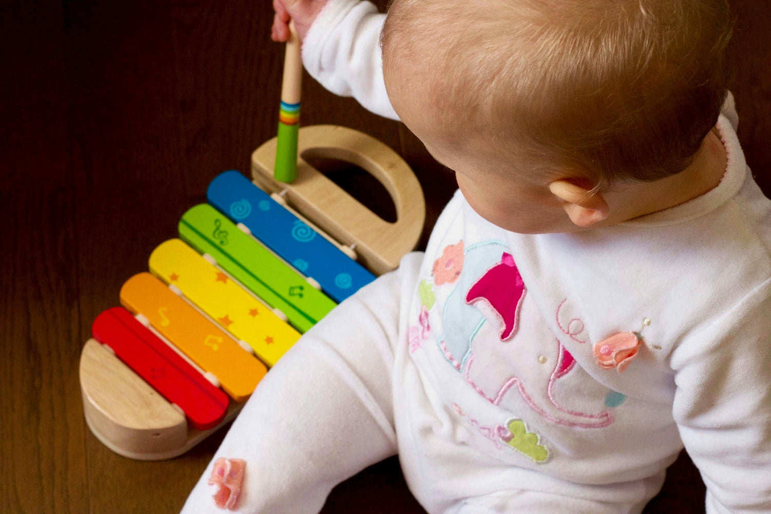 a baby playing with a xylophone